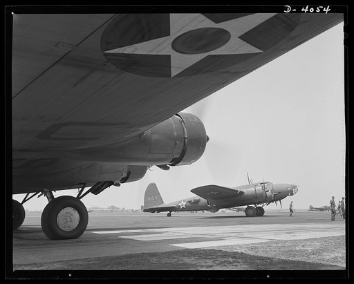 YB-17 bombardment squadron, Langley, Virginia. The profile of a YB-17 bomber as seen from beneath the wing of another plane of the same type. These powerful four-engined ships belong to a bombardment squadron at Langley, Virginia