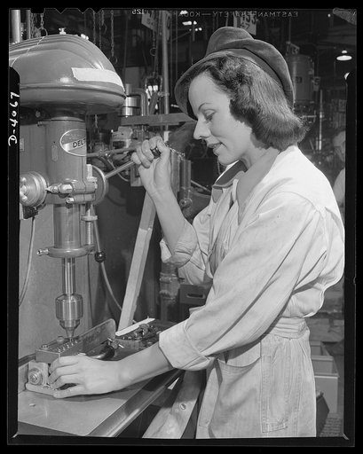 Women aircraft workers. One of the hundreds of photogenic drill press operators who are turning out parts for Uncle Sam's fighting planes in a West Coast airplane factory