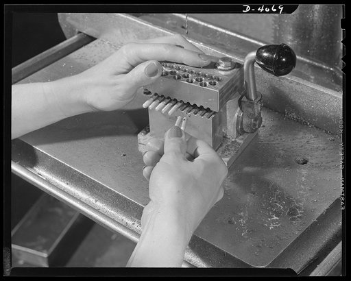 Women aircraft workers. Hands that rocked the cradle operate drill presses today, and surpass their male competitors in speed and precision of work. Site: a West Coast aircraft plant. Lockhead