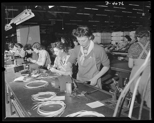 Women aircraft workers. That Hollywood hasn't yet cornered the beauty market is evident by this assembly line crew at a West Coast airplane factory. They're making electrical sub-assemblies in a continuous-line production