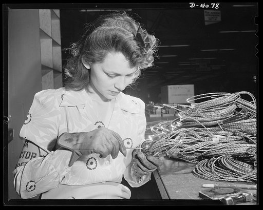 Women aircraft workers. Hollywood missed a good bet when they overlooked this attractive aircraft worker, who is shown checking electrical sub-assemblies in a large West Coast aircraft factory. Vega