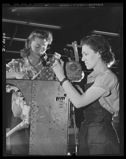 Women aircraft workers. Uncle Sam's fighting men can thank the girls they left behind for the great job they're doing on America's production line. These two young women are working on the control column of a giant bomber at one of the West Coast's aricraft factories. Vega
