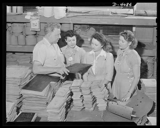 Women aircraft workers. Three little maids in aircraft school? They're learning the use of templates, used in training material for bullet proofing gas tanks in a West Coast airplane factory. Vega