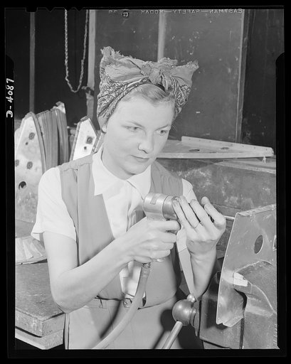 Women aircraft workers. Remember Pearl Harbor? She can't forget it, for Fern Evans's husband was one of America's fighting men who died in action on December 7 aboard the USS West Virginia. Mrs. Evans has been employed at a huge West Coast aircraft plant since February and is supporting herself and 