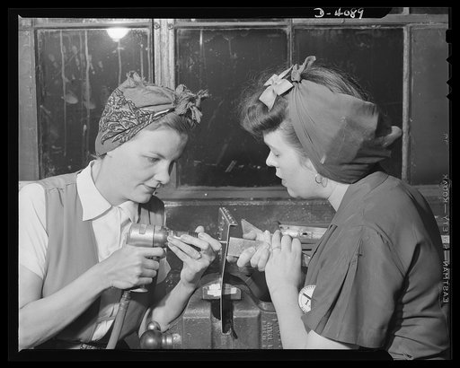 Women aircraft workers. Two Pearl Harbor widows work to defeat the Axis at a West Coast aircraft plnat. Mrs. Fern Evans, left and Mrs. Evelyn J. W. Casola work as a team on the riveting of radio support assemblies for bomber planes. Neither had previous mechanical experience prior to this job, but b