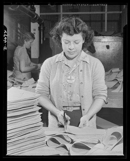 Women aircraft workers. In a West Coast aircraft plant, this young woman is trimming material for the bullet proofing of gas tanks. The material is developed from pure latex, is highly gasoline solvent and seals bullet holes