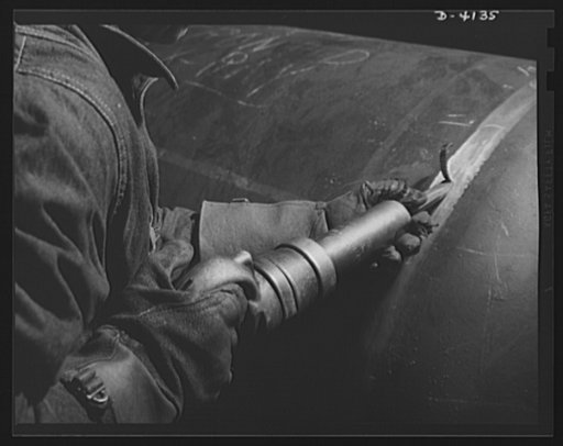 Production. Making boilers. Great care is taken in producing steam boilers for the Army in a big Midwest plant. A defect detected by X-ray examination of the steel is chipped out by an air hammer
