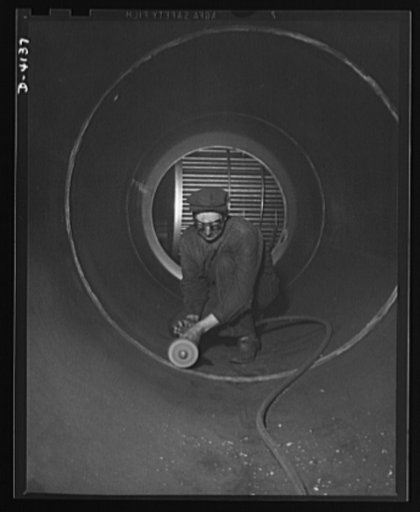 Production. Marine boilers. Grinding of welded seams inside the drum of a large marine boiler at a Midwest plant which has converted its facilities to war production