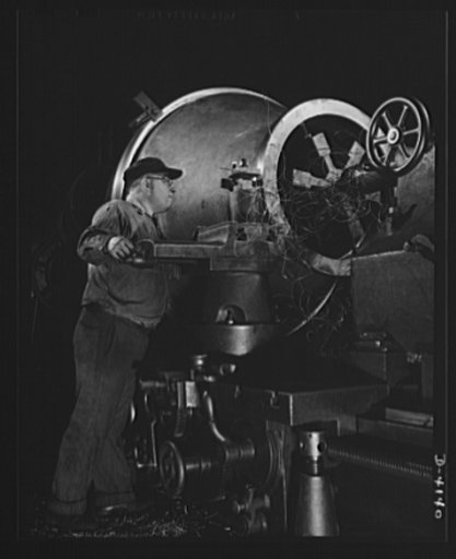 Production. Marine boilers. A flange is turned on a large cone that is part of heat transfer equipment being made for the Army in a big Midwest plant