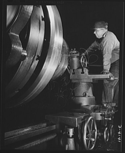Production. Marine boilers. A flange is turned on a large cone that is part of heat transfer equipment being made for the Army in a big Midwest plant