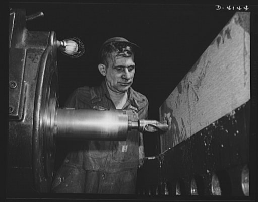 Production. Marine boilers. Burning a hole in a large hyperbolic valve block that will be part of a hyperbolic press in a powder factory. Site: a Midwest plant converted to war production