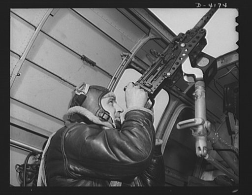 Mitchell Field. An American knight of the air mans the upper gun of one of our new bombers. He, his gun and his plane are typical of the personnel and equipment that have gained world respect for the American Air Force