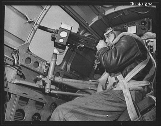 Mitchell Field. The side gun of an American bomber gets plenty of work during an air battle. Manned by a brave, able, well-equipped gunner, it's one of the tools that is steadily thinning out Japanazi air power
