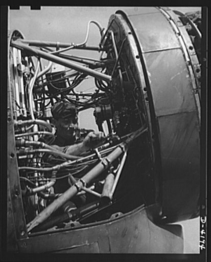Mitchell Field. "Plumbing system" of a fighting plane. The rear end of an air-cooled aviation engine with cowling removed, showing fuel lines, ignition leads, instrument leads and other intimate portions of the anatomy of a mighty flying power plant