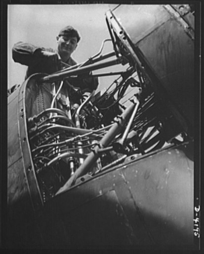 Mitchell Field. "Plumbing system" of a fighting plane. The rear end of an air-cooled aviation engine with cowling removed, showing fuel lines, ignition leads, instrument leads and other intimate portions of the anatomy of a mighty flying power plant