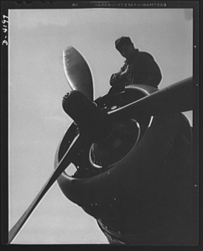 Mitchell Field. Business end of a bomber engine. The controllable pitch housing in the propeller hub assembly contains the mechanism that automatically adjusts the set of the three propellers
