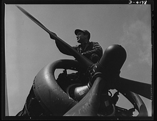 Mitchell Field. Business end of a bomber engine. The controllable pitch housing in the propeller hub assembly contains the mechanism that automatically adjusts the set of the three propellers