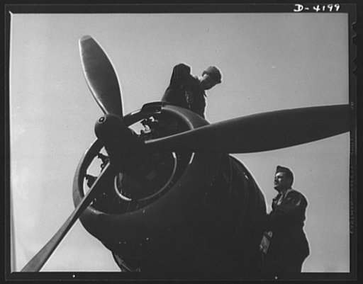 Mitchell Field. Business end of a bomber engine. The controllable pitch housing in the propeller hub assembly contains the mechanism that automatically adjusts the set of the three propellers