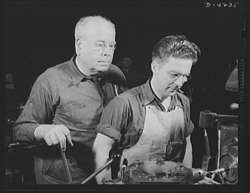 Production. Diesel engines. Old hands and green hands back America's war production drive. An apprentice learning to operate a screw machine at a Midwest plant producing diesel engines for the Navy