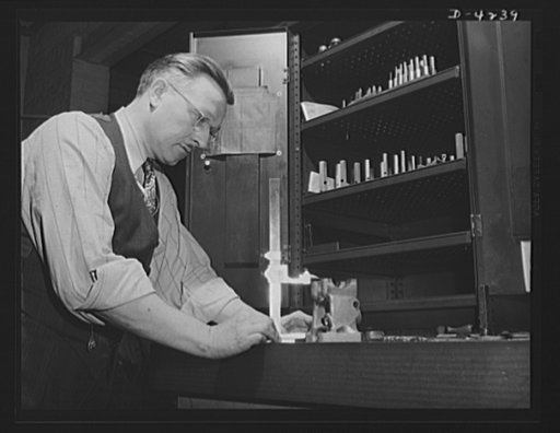 Production. Diesel engines. An inspector at a Midwest plant measures precision parts that will go into diesel engines being made for the Navy