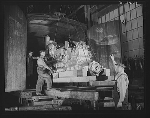 Production. Diesel engines. More power for the Navy. A diesel engine is loaded into a railroad car for shipment from a Midwest manufacturing plant