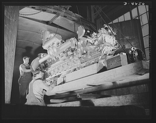 Production. Diesel engines. More power for the Navy. A diesel engine is loaded into a railroad car for shipment from a Midwest manufacturing plant