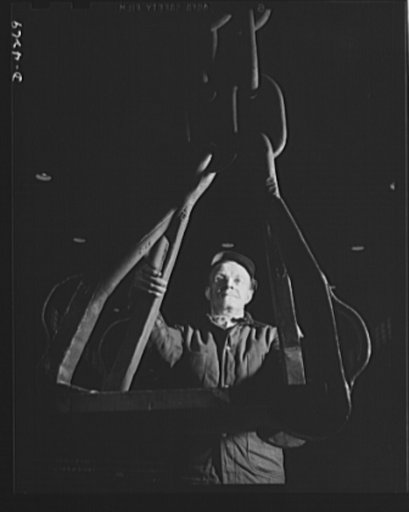Tank armor production. Carnegie-Illinois Steel Corporation. Farrell, Pennsylvania. Large mill plates for the making of tank armor plate are handled with heavy crane hooks during the heat treating, rough flattening and abrasive