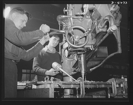 Tank armor production. Carnegie-Illinois Steel Corporation. Farrell, Pennsylvania. Rivet holes for the armor plates of military tanks are run on a vertical drill press in an Eastern mill