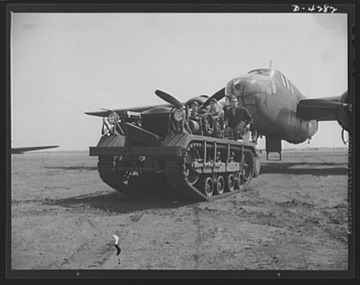 Mitchell Field. An airdrome tractor and its capable crew have no difficulty moving the largest aircraft