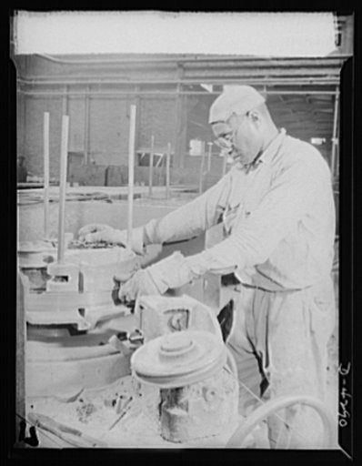 Negro steelworker. This skilled Negro worker is operating a wire-drawing machine which draws steel strips through a die into wire in a large East Coast steel mill. Bethlehem Fairfield Steel