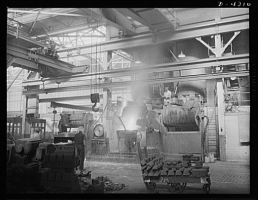 Production. Milling machines and machine castings. This picture shows the general setup on the foundry floor. Notice the overlapping cranes (above and left). Any one of four cranes can come in to pick up full ladles, depending on their size and destination. Location: a large Midwest machine tool fou