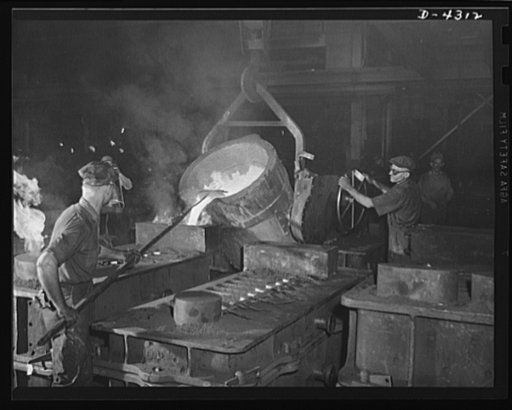 Production. Milling machines and machine castings. Pouring a large mold is a fiery sight. To the left, flames are shooting from an escape hole -- caused by gas generated by the contact of iron with the relatively cool sand, graphite, linseed oil and other ingredients involved in the mold structure. 