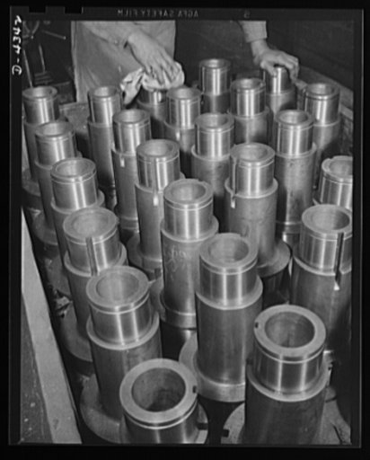 Production. Milling machines and machine castings. Polishing spindle sleeves in a large Midwest plant producing essential machine tools for the war production program