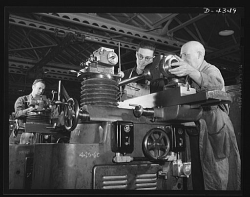 Production. Milling machines and machine castings. A universal cutter sharpening machine for keeping fit the cutting tools that are used by other machine tools. Here the machine is being carefully inspected in the runoff line. Location: a large Midwest machine tool plant