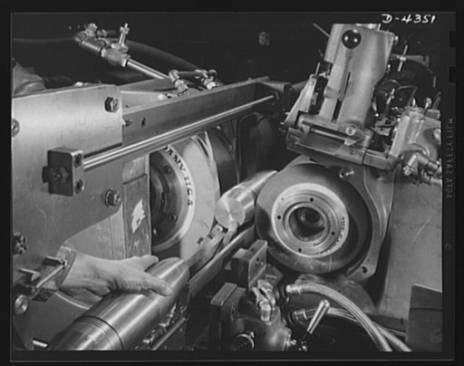 Production. Milling machines and machine castings. Another scene in the runoff line where three-inch shells are being run through a centerless grinding machine which grinds them to exactly correct roundness, size, straightness and smoothness. Designed to be blown to bits as soon as possible, each sh