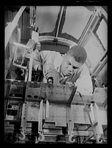 Manpower. Negro bomber plant workers. From bottom to top, America's bombers are being produced with all the workers of the nation. This Negro worker is speeding the final assembly of the floor in the pilot's compartment of a medium bomber in one of America's largest bomber plants. Glenn L. Martin Bo