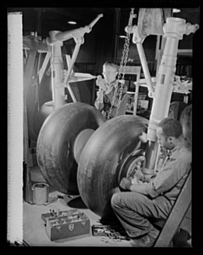 Manpower. Negro bomber plant workers. Landing gear for American medium bombers, which will carry destruction to the heart of the Axis, is assembled in a large Eastern aircraft plant. These skilled mechanics are products of the government's extensive training program for war workers. Glenn L. Martin 