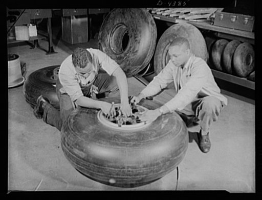 Manpower. Negro bomber plant workers. Conservation of rubber by American motorists makes possible these bomber tires, which are being assembled in a large Eastern aircraft plant. These Negro workers are clamping on lock washers to the wheels before final assembly of the landing gear. Glenn L. Martin