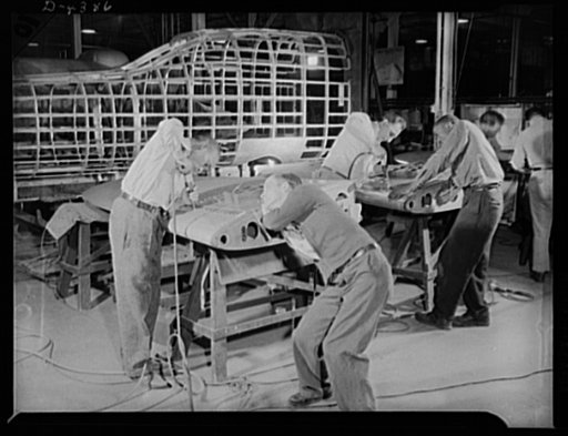 Manpower. Negro bomber plant workers. American manpower teaming up to beat the Axis. Negro and white employees of a large Eastern aircraft factory work together in attaching skins to the fins of medium bombers. Glenn L. Martin Bomber Plant. Baltimore, Maryland