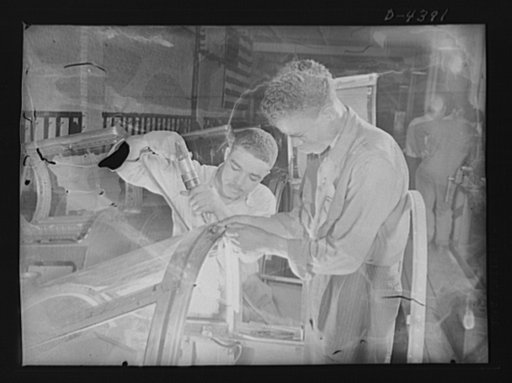 Manpower. Negro bomber plant workers. Final assembly of the pilot's compartment is being made by these Negro workers in a large Eastern aircraft factory. These youths went directly from a war training course to their jobs in this plant. Glenn L. Martin Bomber Plant. Baltimore, Maryland