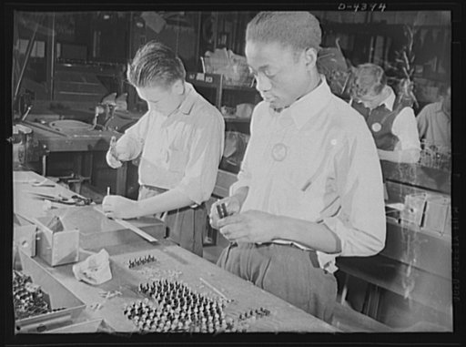 Manpower. Negro bomber plant workers. Americans of various racial groups provide manpower for war industries. These youths, employees in a large Eastern bomber plant, are assembling bomb indicators. Both are graduates of government war training courses. Glenn L. Martin Bomber Plant. Baltimore, Maryl
