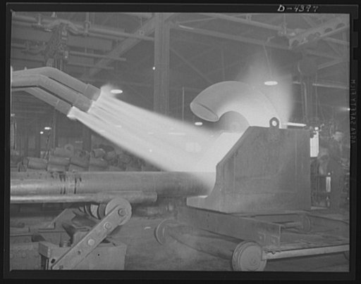 Production. Pipe fittings. Large pipe elbows for the Army are formed in a Midwest plant by heating lengths of pipe with gas flames and forcing them around a die. Tube Turn Incorporated