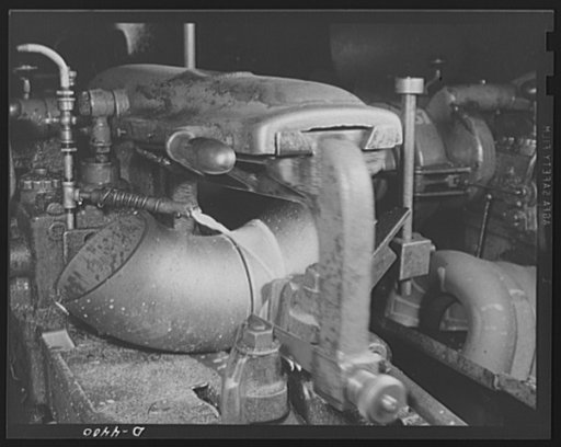 Production. Pipe fittings. Pipe fittings for the Army. A power saw cuts a pipe elbow to size in a Midwest plant. Elbows are cut to any length and angle from bent pipe