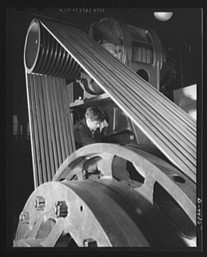 Production. Pipe fittings. The V-belt drive of the world's largest machine of its kind, a nine inch upsetter. The machine is used in a Midwest plant to forge 75 mm shells for the Army. Tube Turn Incorporated