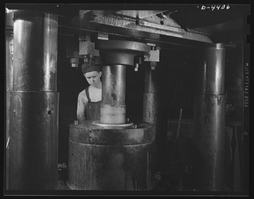 Production. Pipe fittings. A giant press used in a Midwest plant now forging 75 mm shells for the Army. Tube Turn Incorporated
