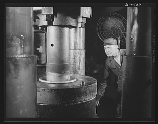 Production. Pipe fittings. A giant press used in a Midwest plant now forging 75 mm shells for the Army