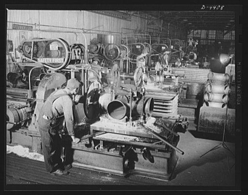 Production. Pipe fittings. Finishing department of large Midwest plant producing pipe fittings for the Army. Here fittings made by bending straight pipe pass through beveling and other machine operations that prepare them for later welding. Tube Turn Incorporated