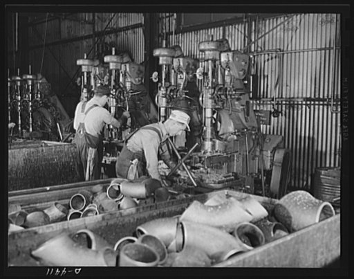 Production. Pipe fittings. Beveling a large pipe elbow to prepare it for butt welding. Elbows like this, for use in Army equipment, are made by bending straight pipe in a large Midwest plant. Tube Turn Incorporated