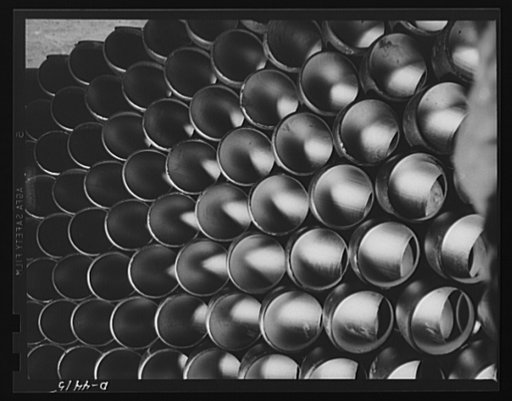 Production. Pipe fittings. Huge stocks of pipe fittings for Army equipment are being built up steadily in a big Midwest plant. The fittings are made by bending straight pipe, cutting off desired lengths from the curved sections and beveling edges for butt welding. Tube Turn Incorporated