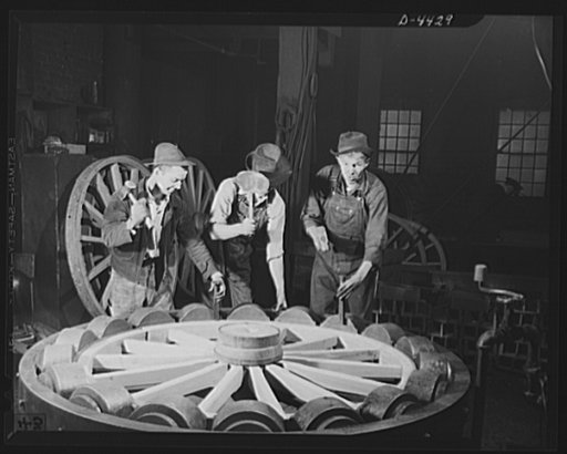 Production. Wagon wheels. Revival of a dying art. Fitting the steel tire to the wagon wheel assembly in the plant of a Southern wagon company which is experiencing a business boom because of the rubber shortage